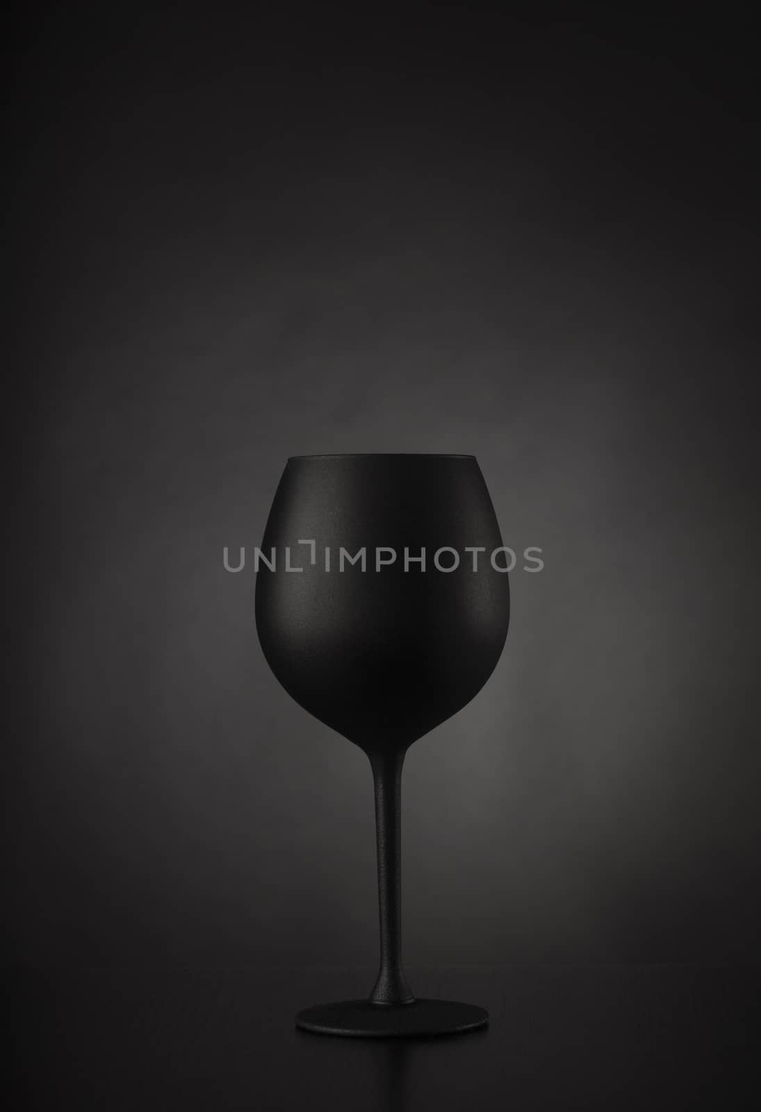 Black glass of wine on black background