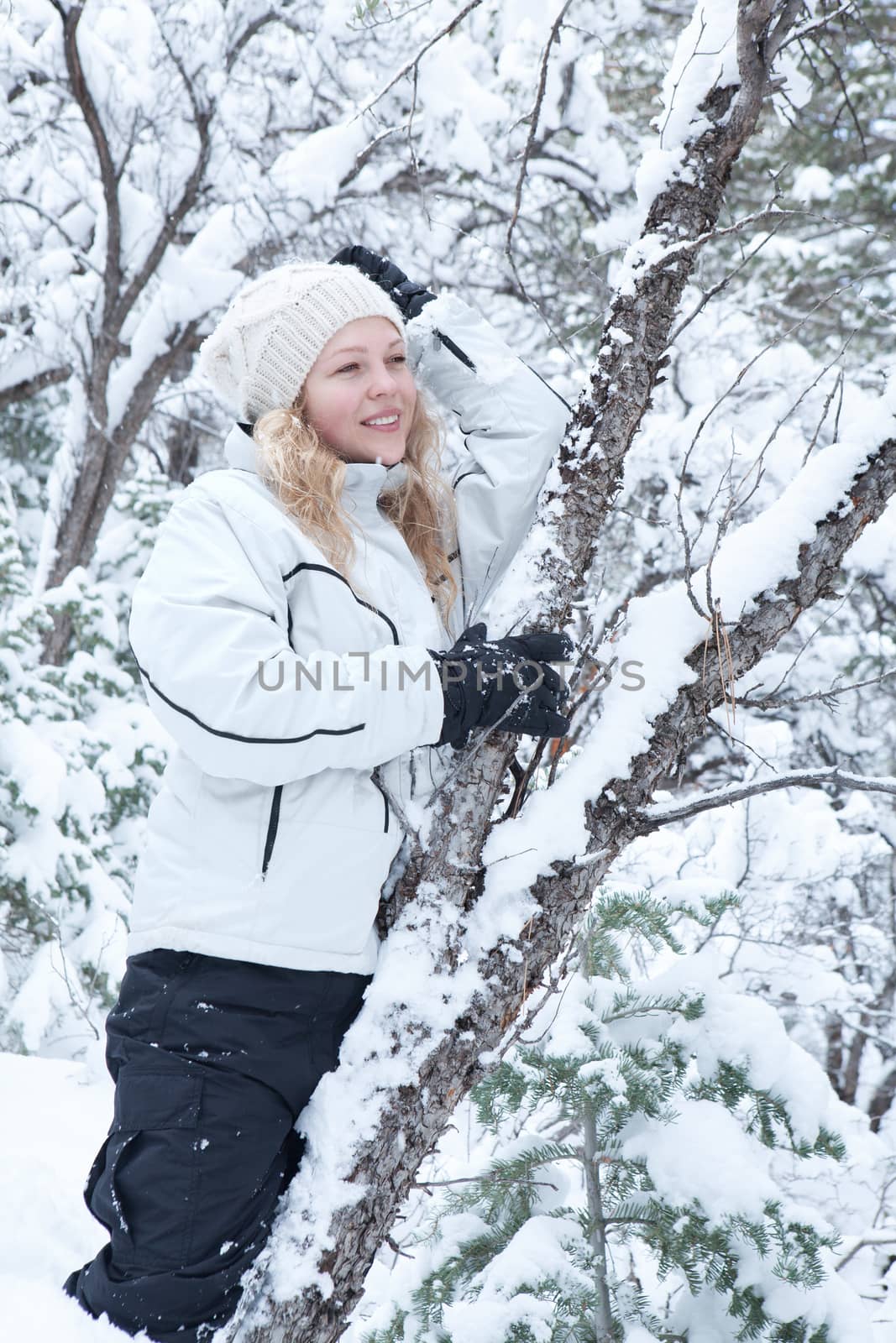 Portrait of young beautiful woman on winter outdoor background