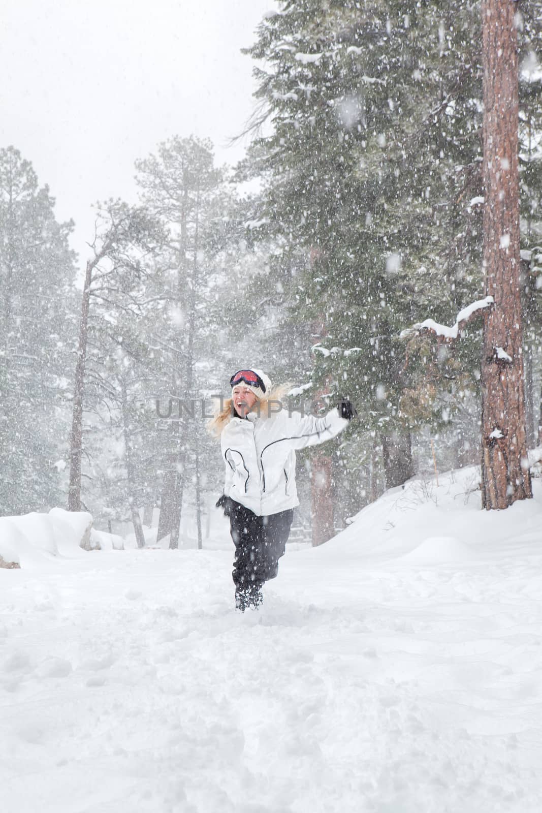 Portrait of young beautiful woman on winter outdoor background