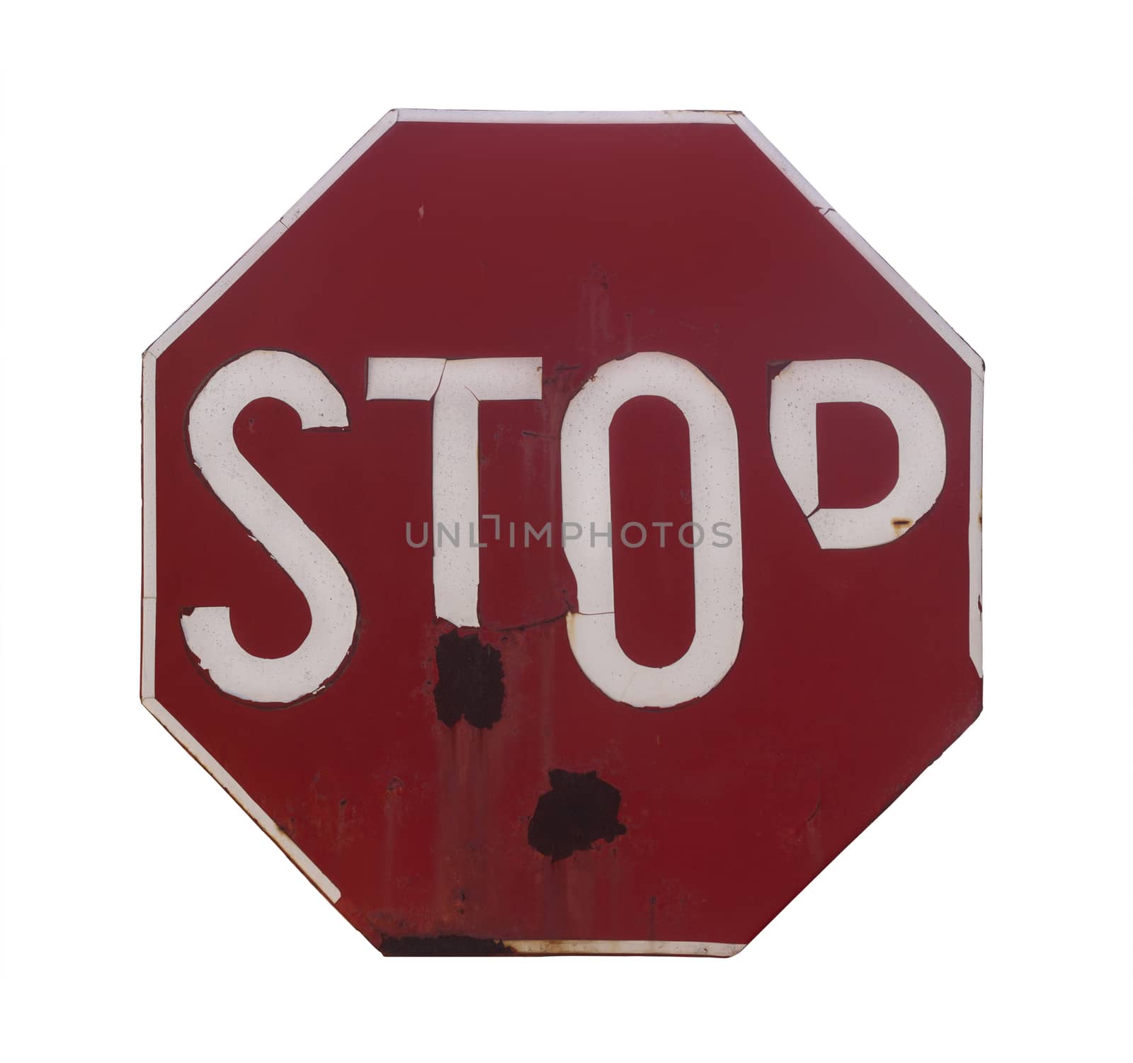 Front view of a rusted red stop sign with the word stop written isolated on white background