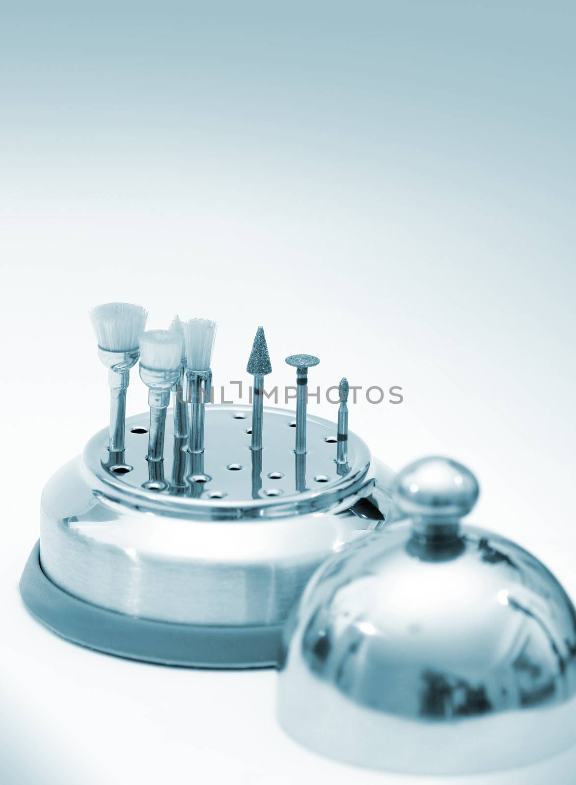 Set of chrome dental drills, viewed from the side with shallow depth of field
