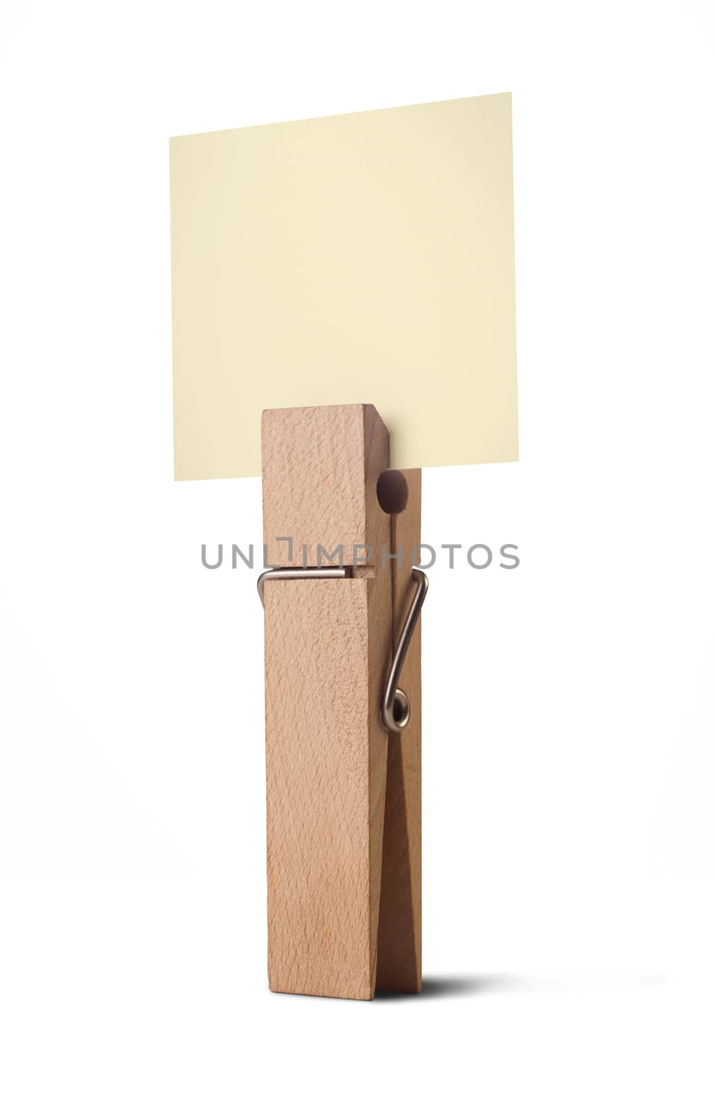 wooden peg holding a yellow note isolated on white background