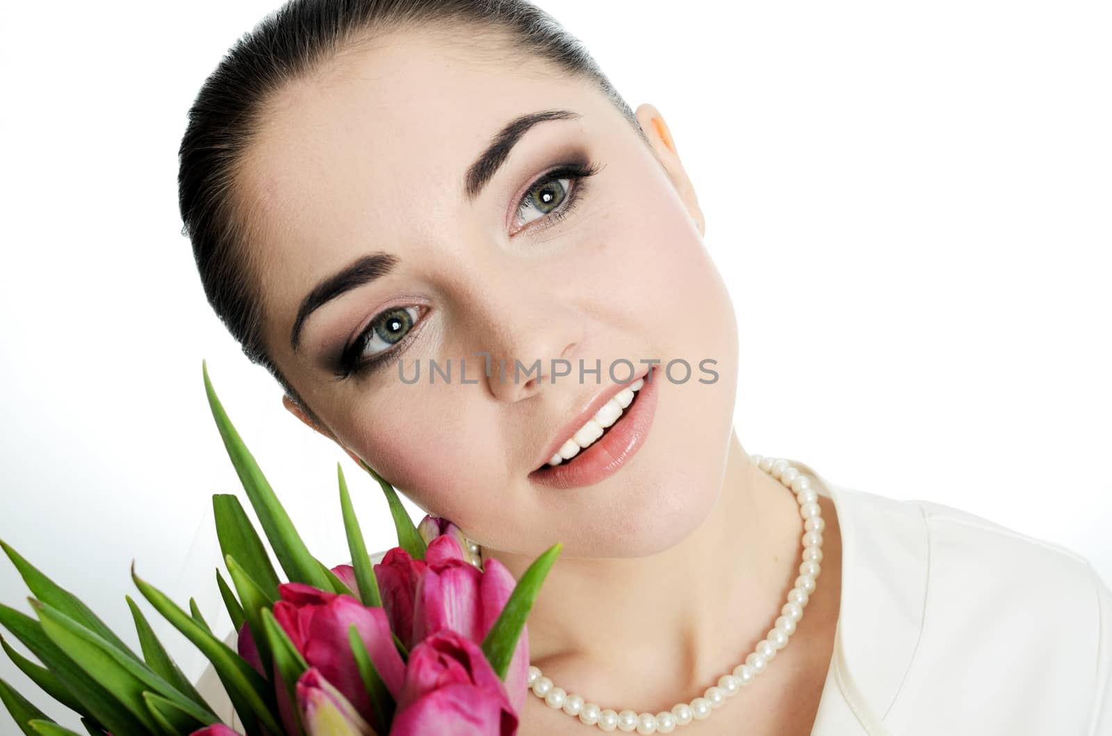 Happy bride with white veil and tulips bouquet in her hand. Young, happy female model.
