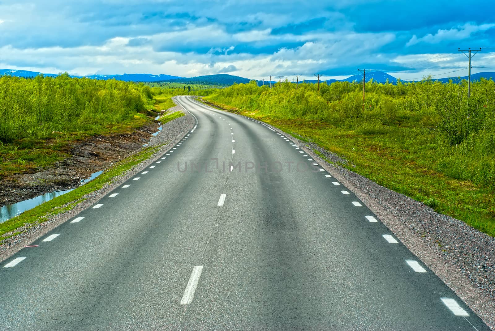 Grey sweden road to Norvegian mountains in sunny summer day by BIG_TAU