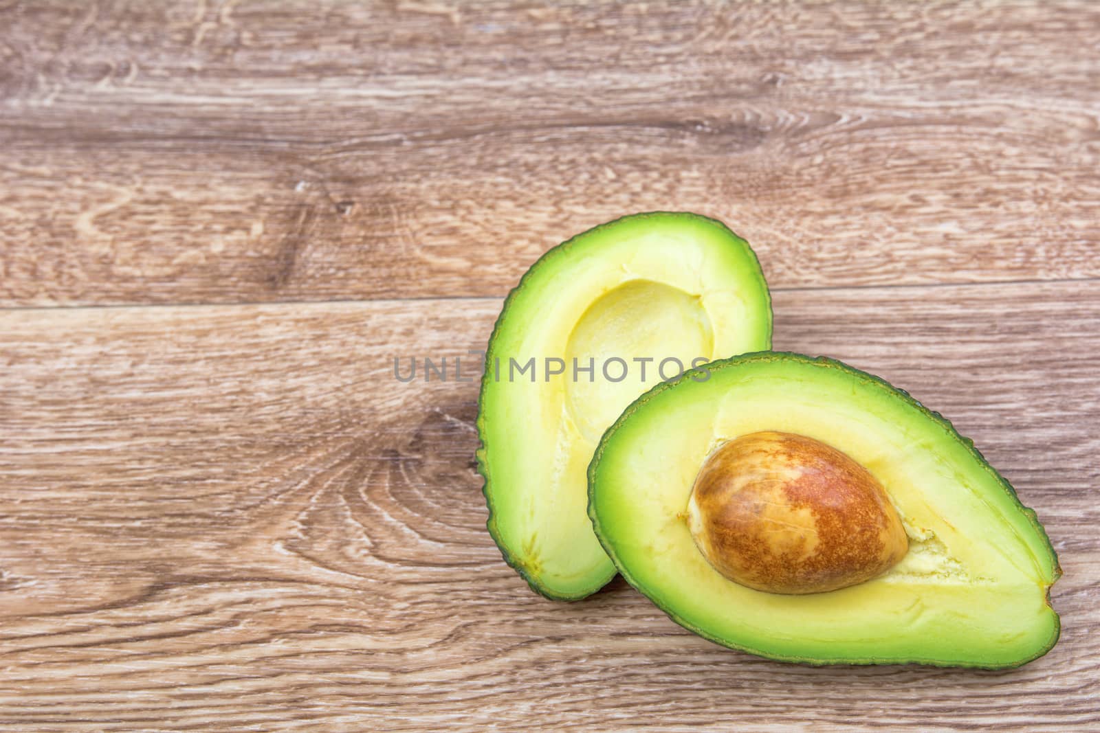 Cut avocado on a wooden background