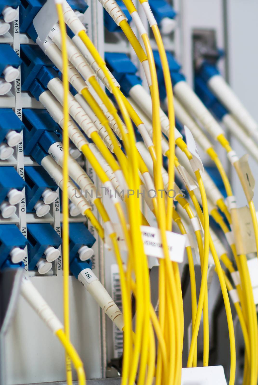 fiber optic with servers in a technology data center by panumazz@gmail.com