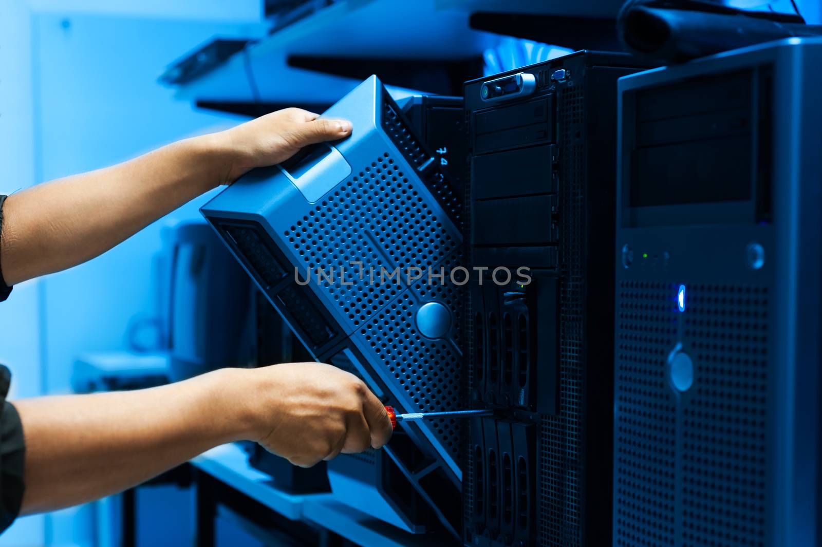 Man fix server network in data center room .