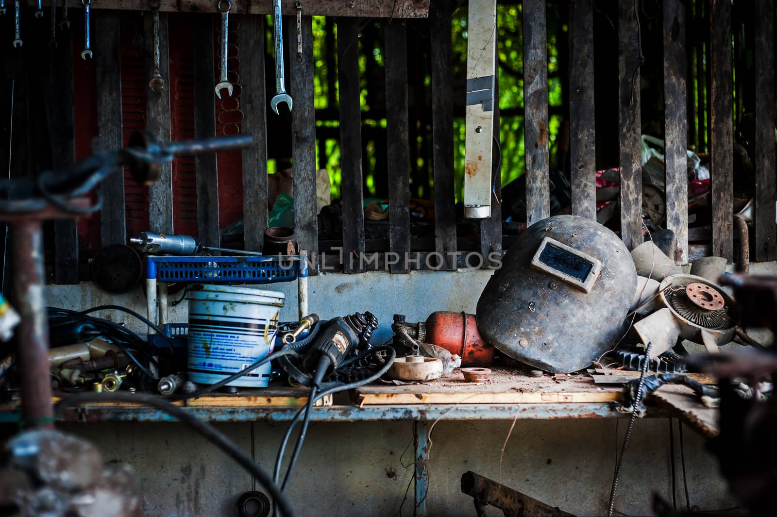 Welding helmet still life in equipment room .