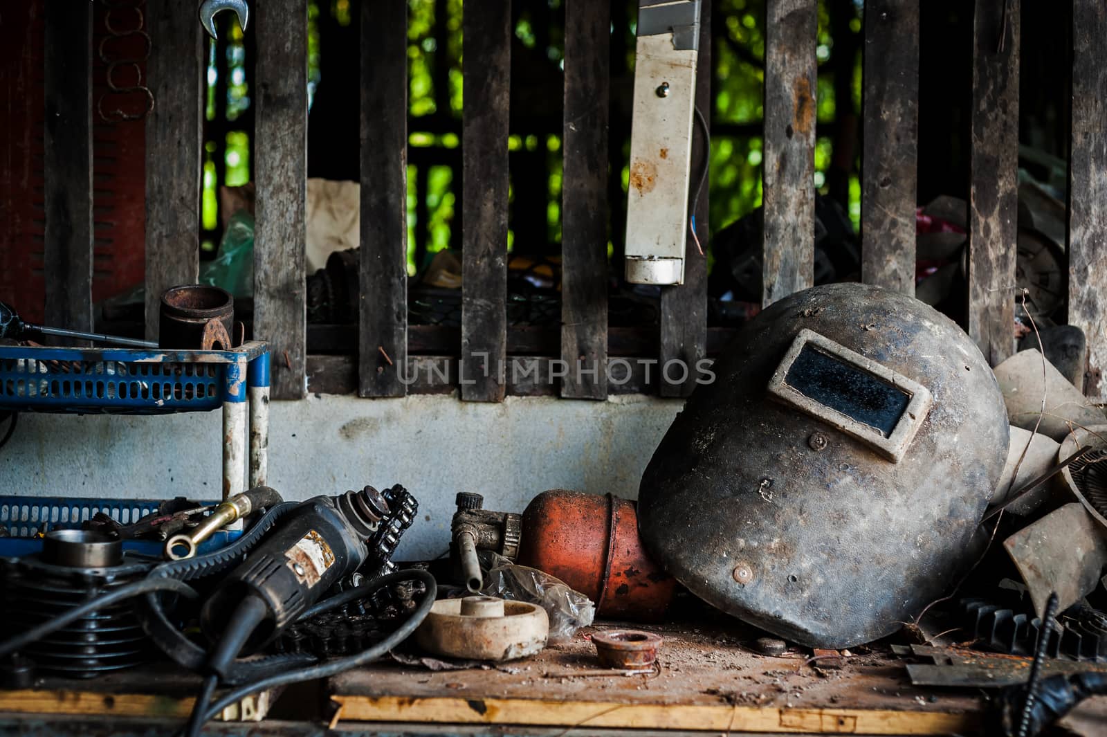 Welding helmet still life in equipment room .