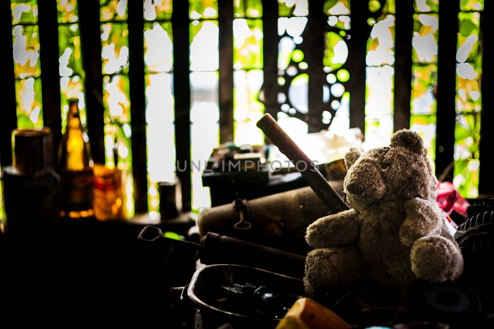 AnBear doll with Old tool in dirty place .