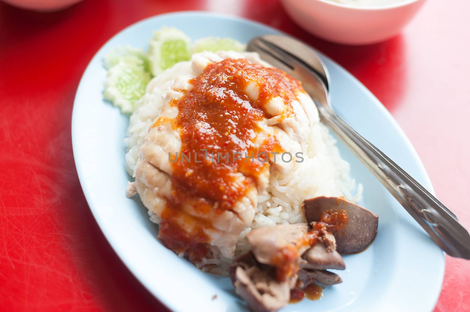 Chicken and rice thai food in soft light .