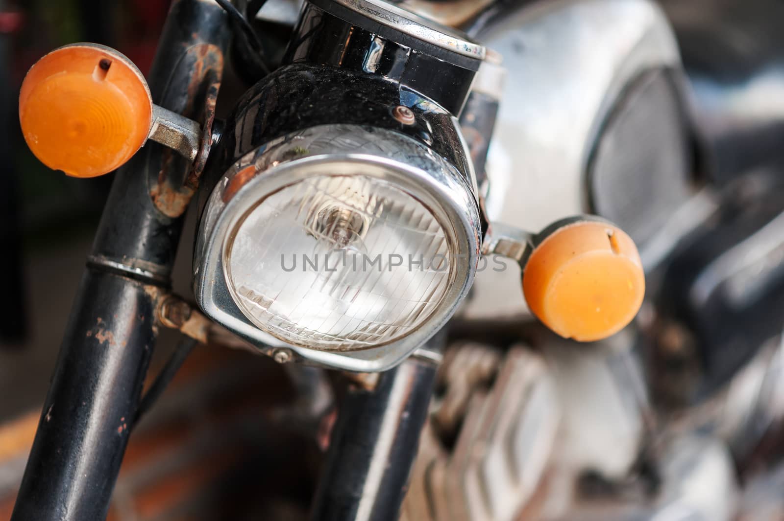 An Old motorcycle in vintage place .