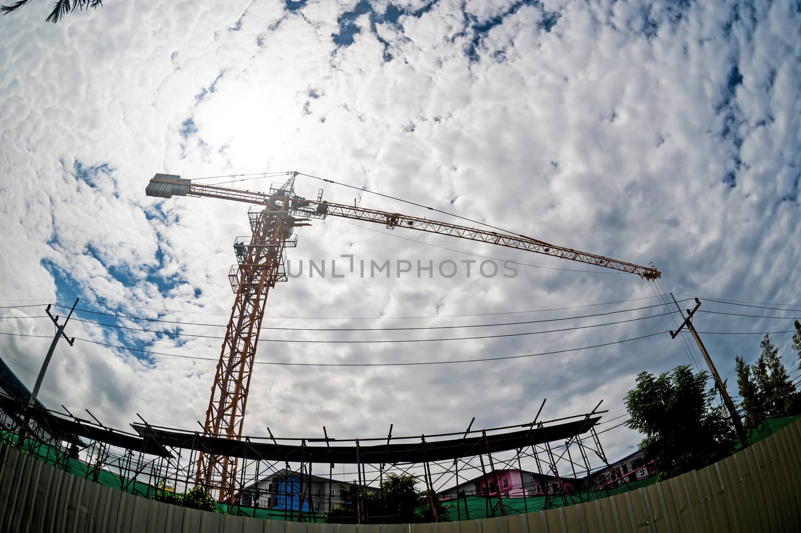 An Crane in construction with blue sky .