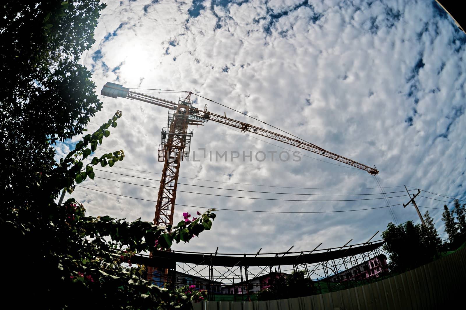 An Crane in construction with blue sky .