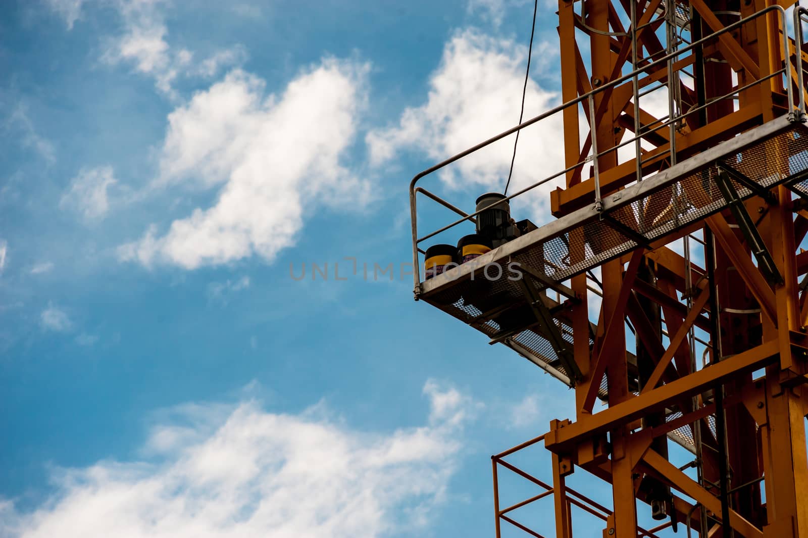 An Crane in construction with blue sky .