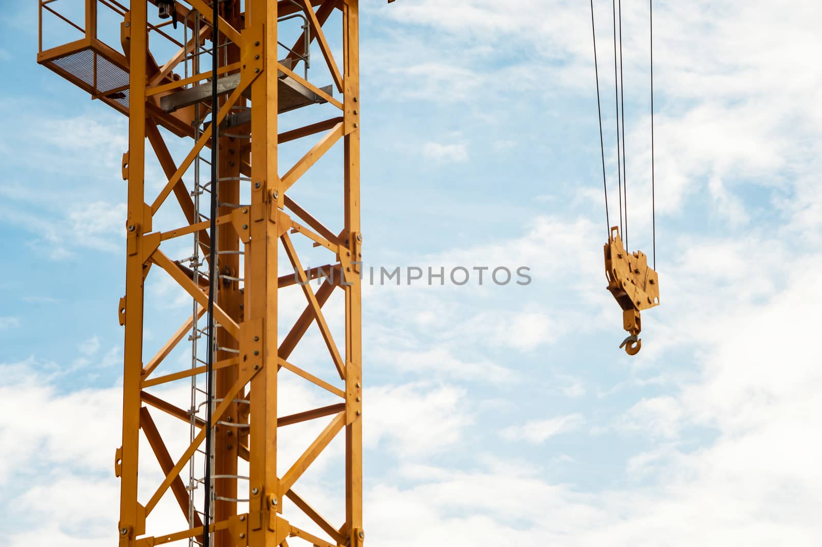 An Crane in construction with blue sky .