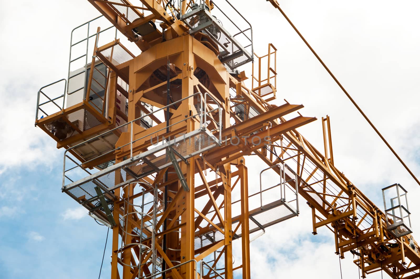 An Crane in construction with blue sky .