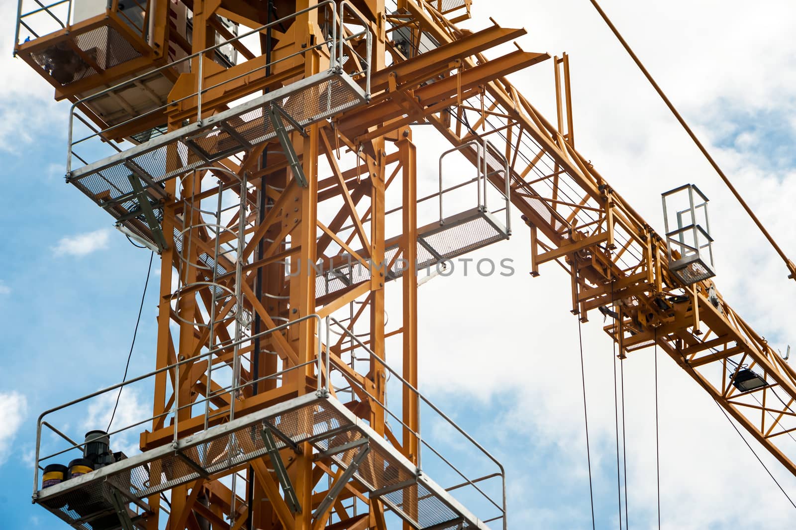 An Crane in construction with blue sky .