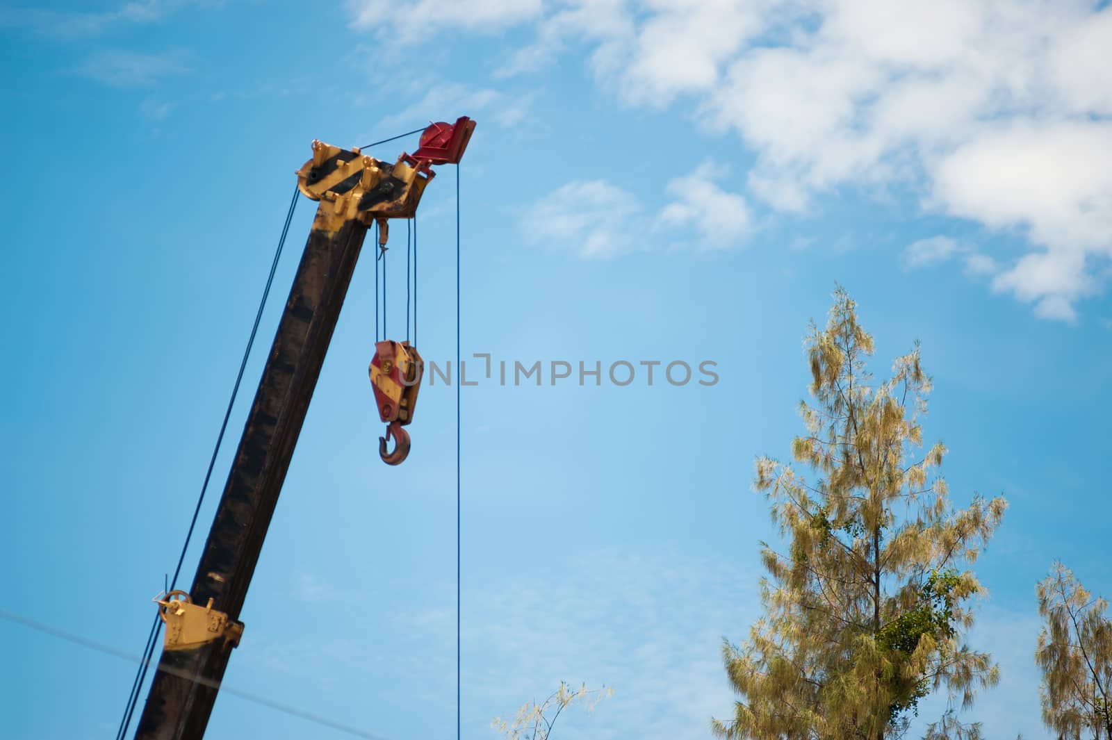 An Crane in construction with blue sky .