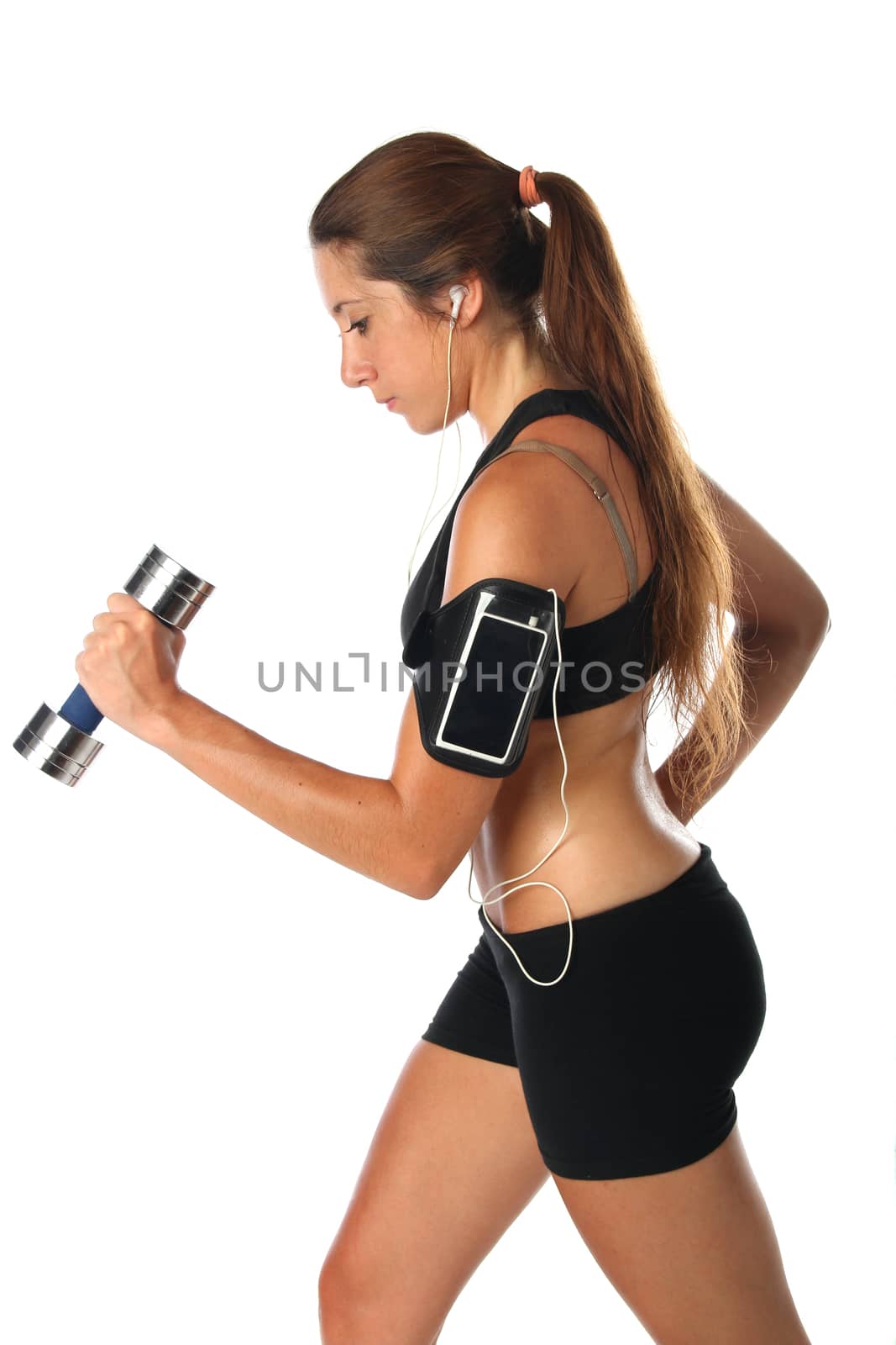 Young woman exercising with dumbbells and a smartphone. Isolated