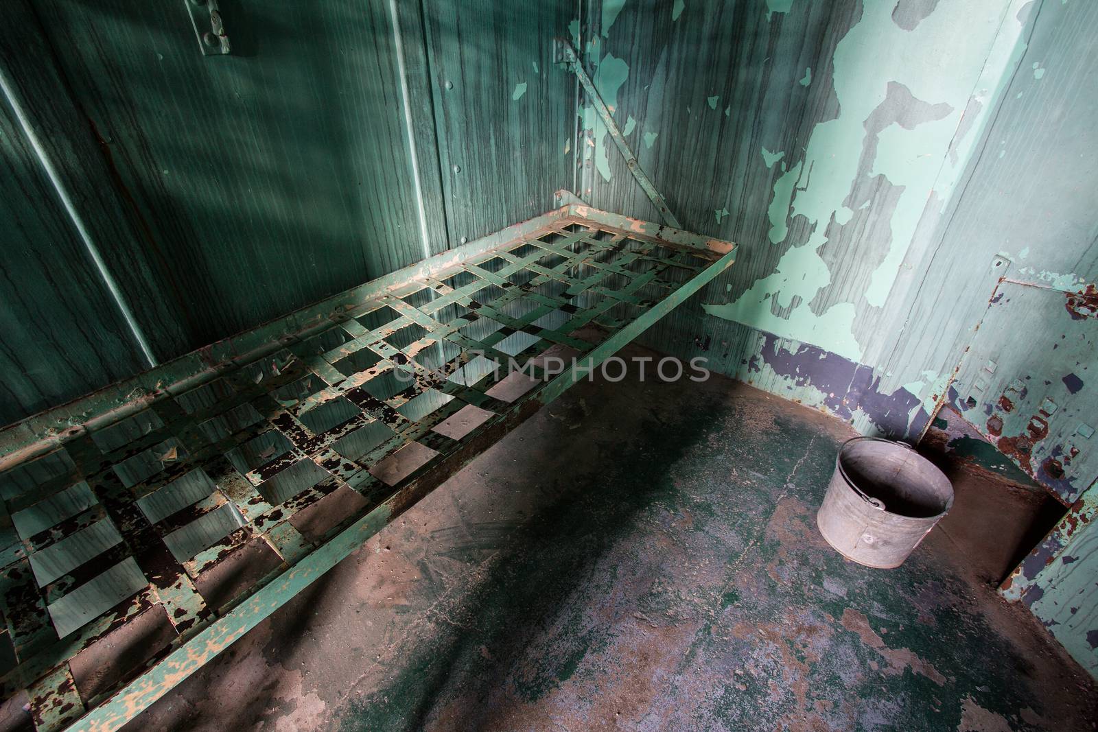 wide angle view of an old prison bed