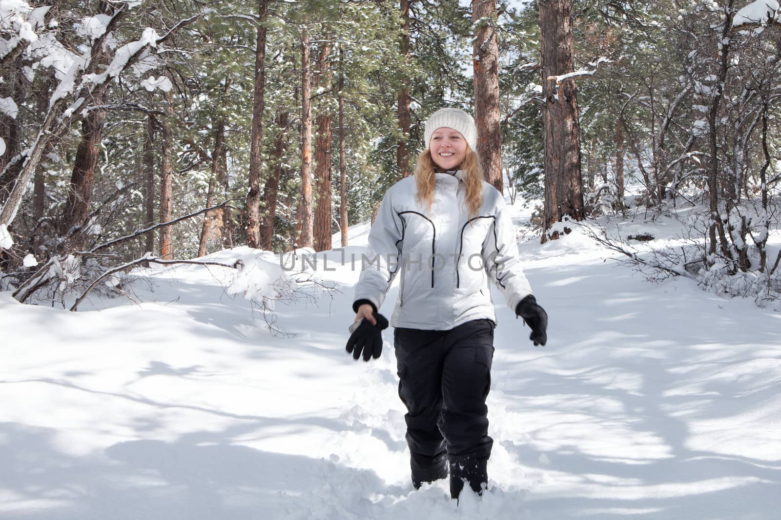 Portrait of young beautiful woman on winter outdoor background