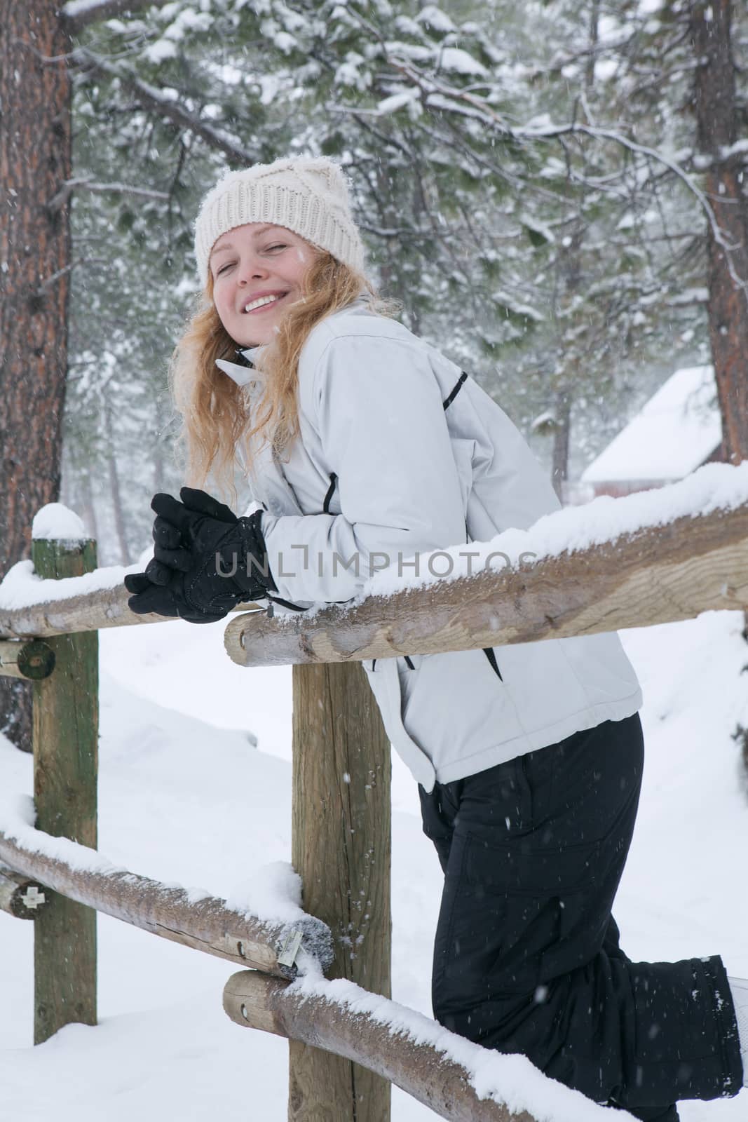 Portrait of young beautiful woman on winter outdoor background