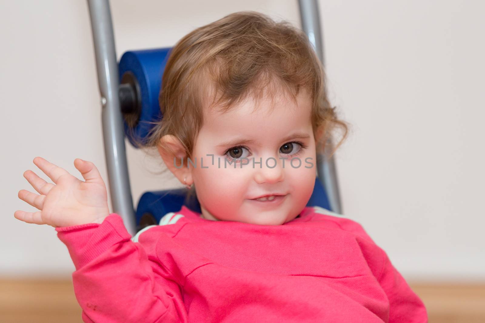 Happy cute little one year old girl indoor in white pink dress