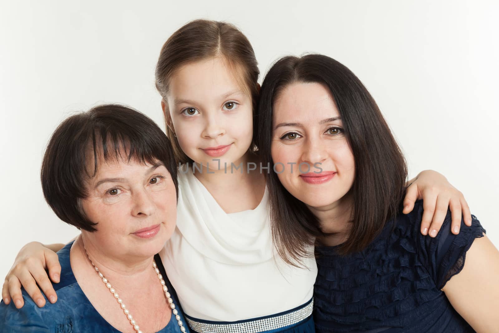 The granddaughter embraces the grandmother and mother  by sveter
