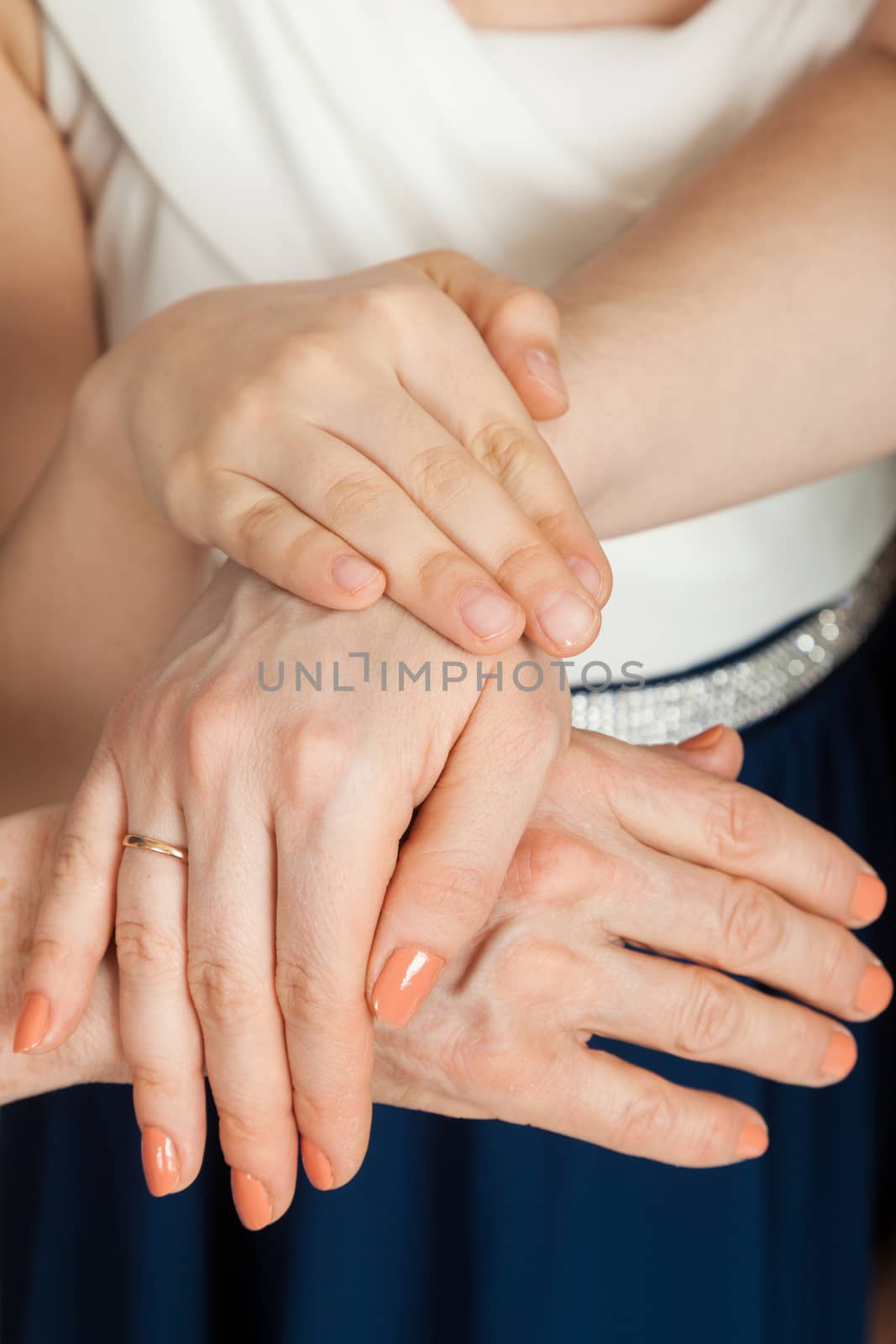 the girl's hand on hands of mother and grandmother