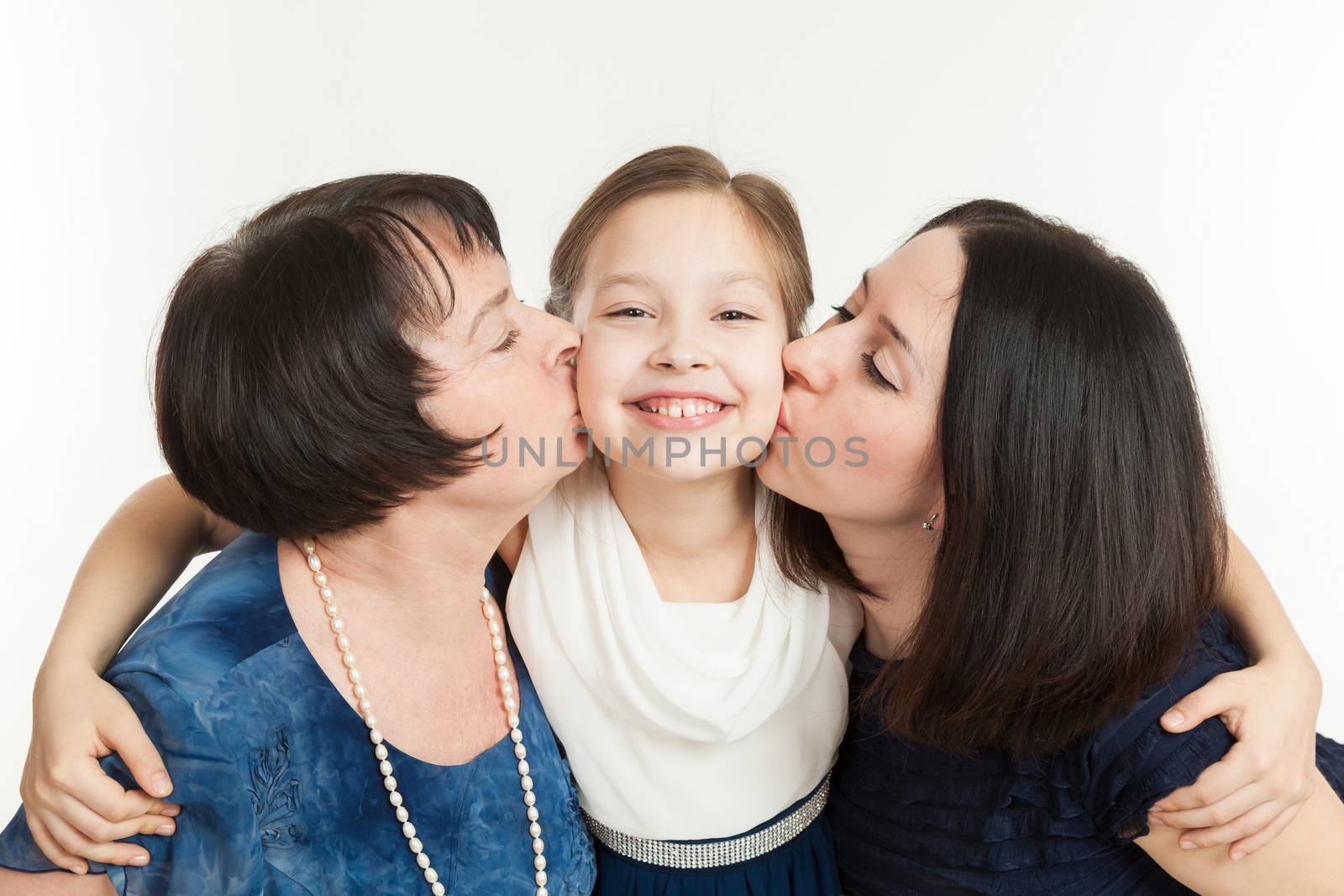 the grandmother and mother kiss the granddaughter on a white background