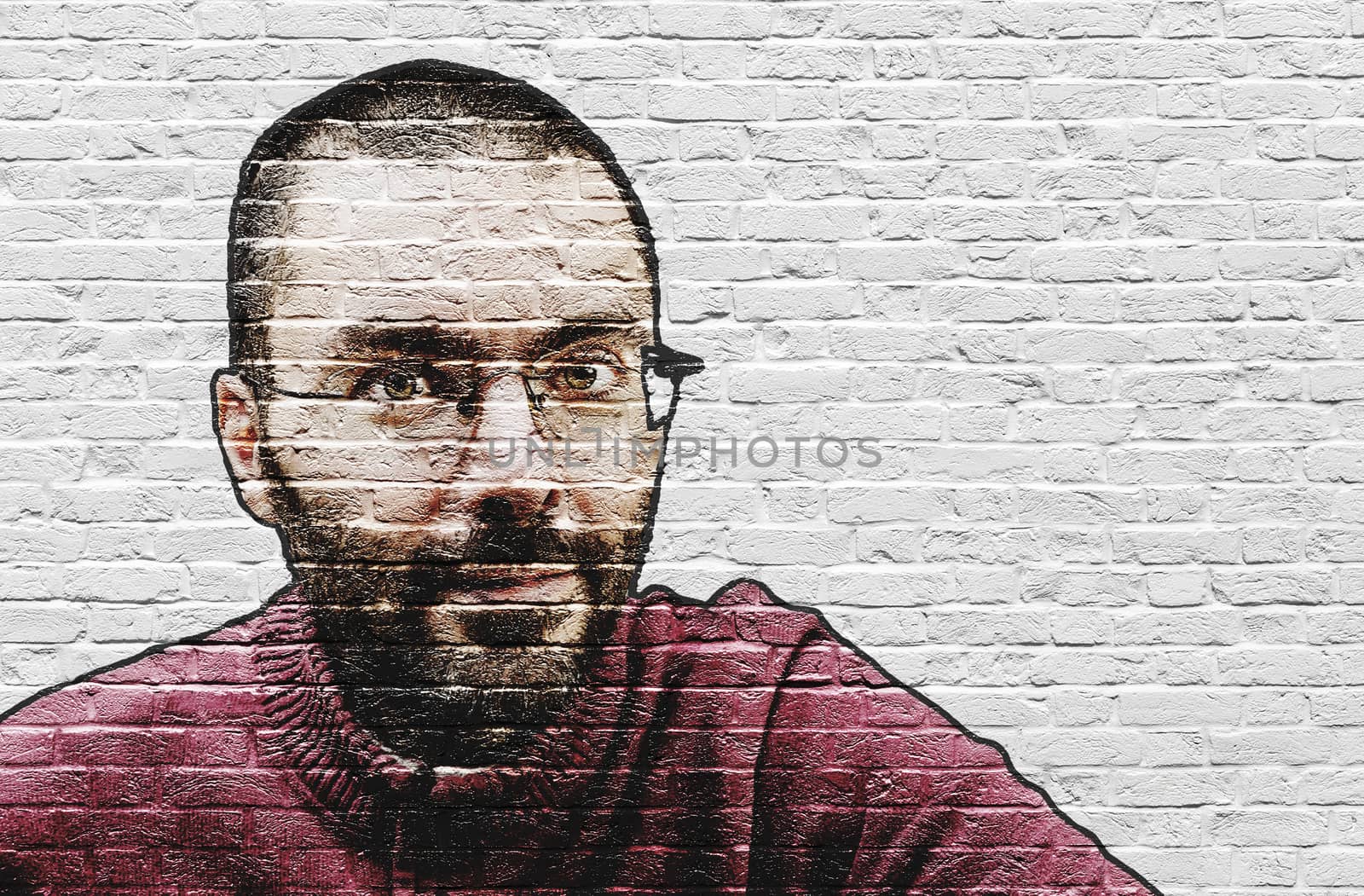 Grinning bearded man in glasses and red sweater with close shave painted on white brick wall