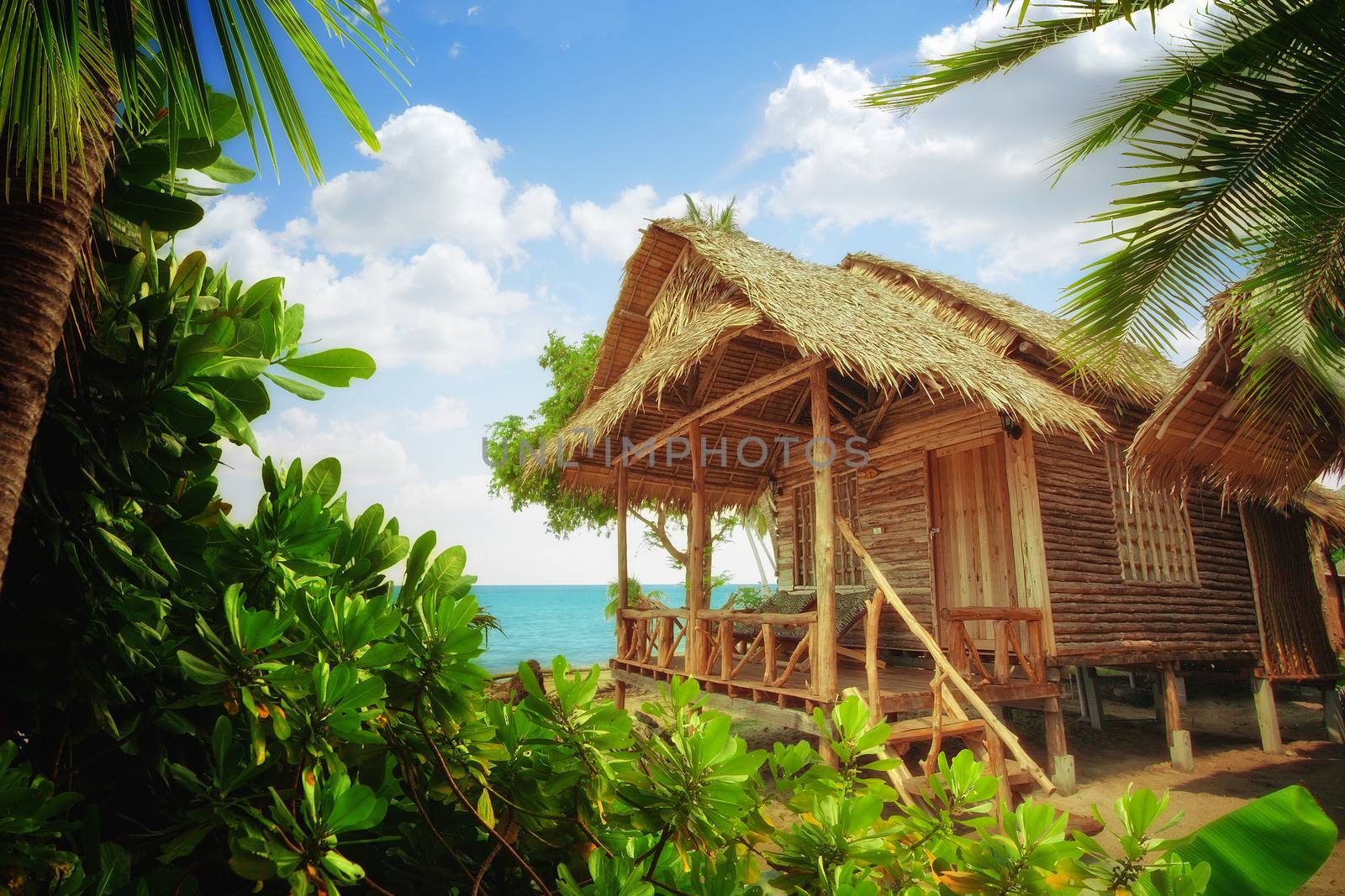 view of nice exotic bamboo hut on tropical beach