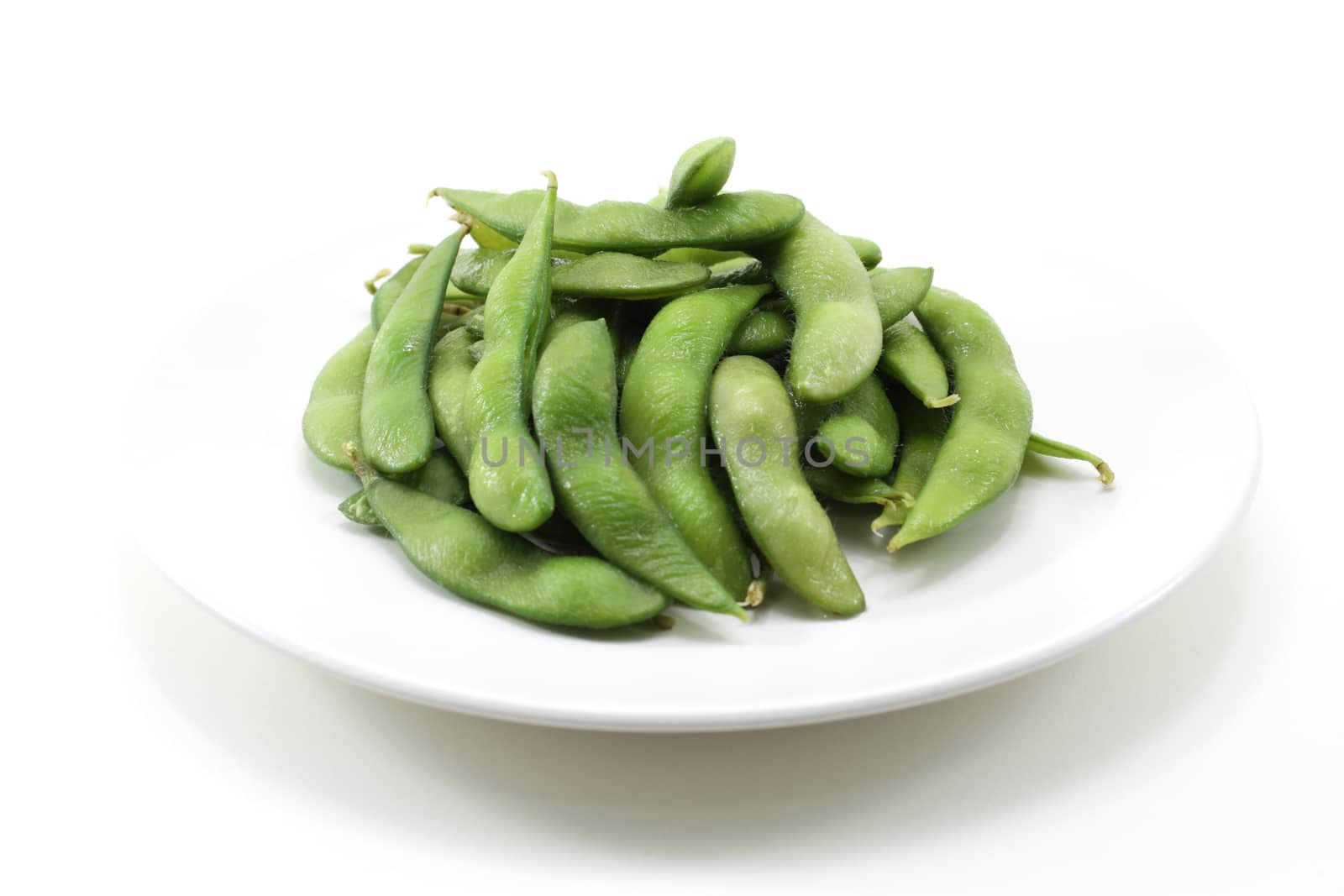 Close green soybeans on white background