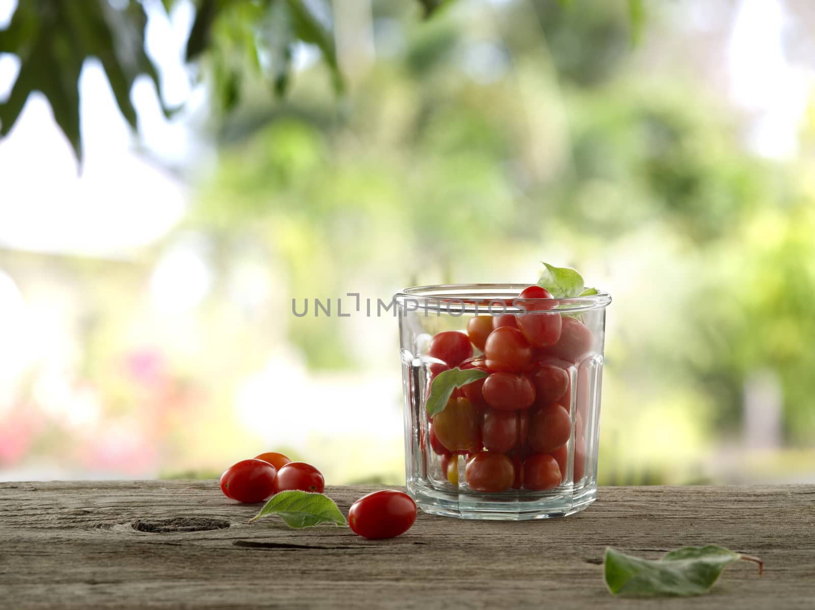 close up view of nice fresh cherry tomatoes on wooden table