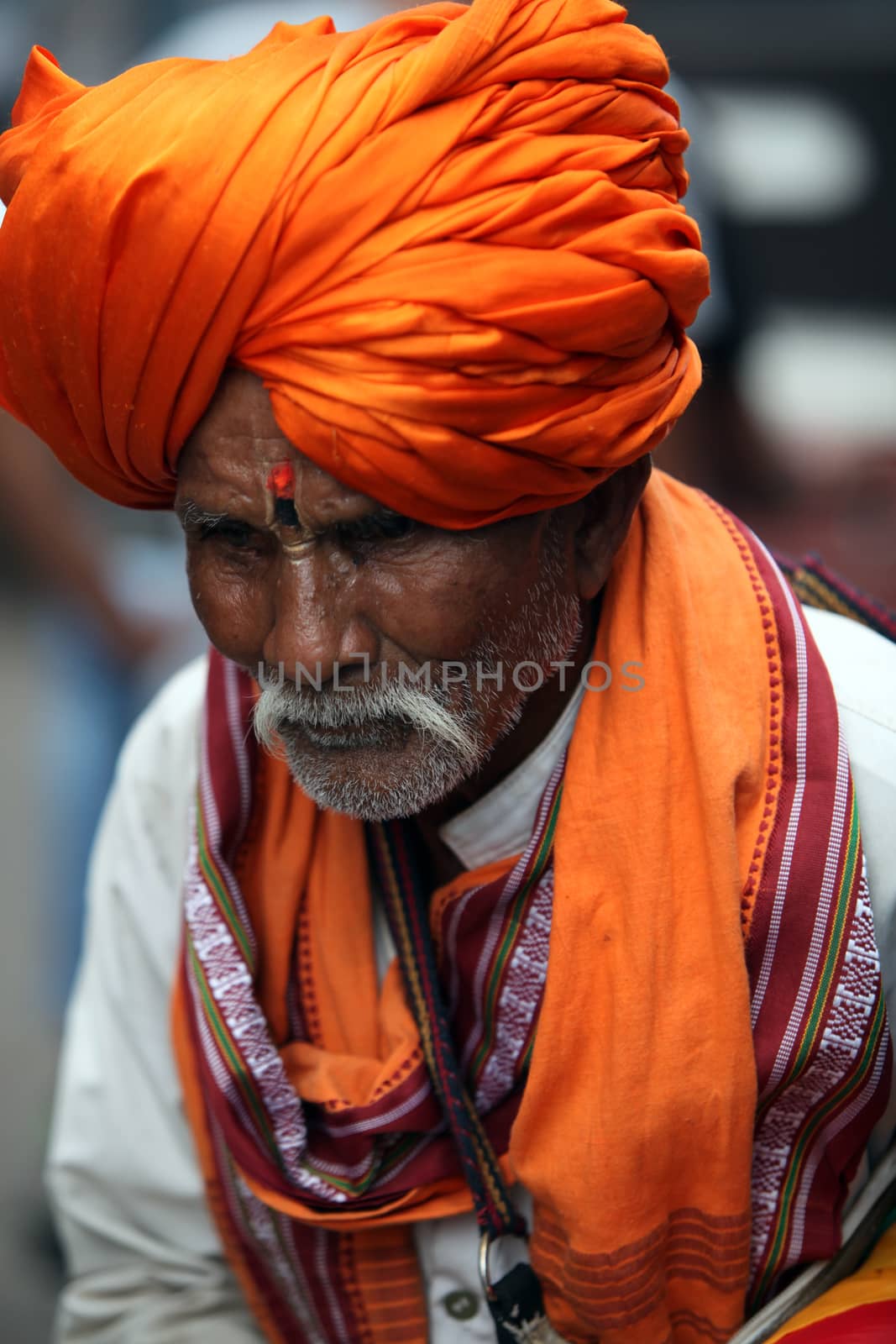A very old pilgrim from India in his traditional attire of a saffron colored turban, the color generally represents Hinduism.