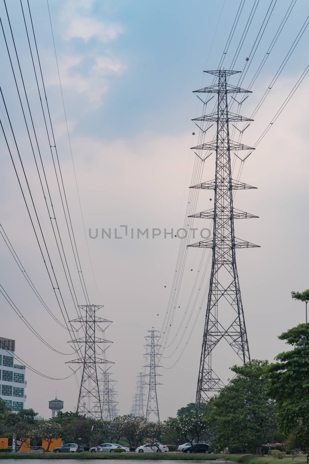 Electric Transmission Tower with sky background in a village by MCVSN