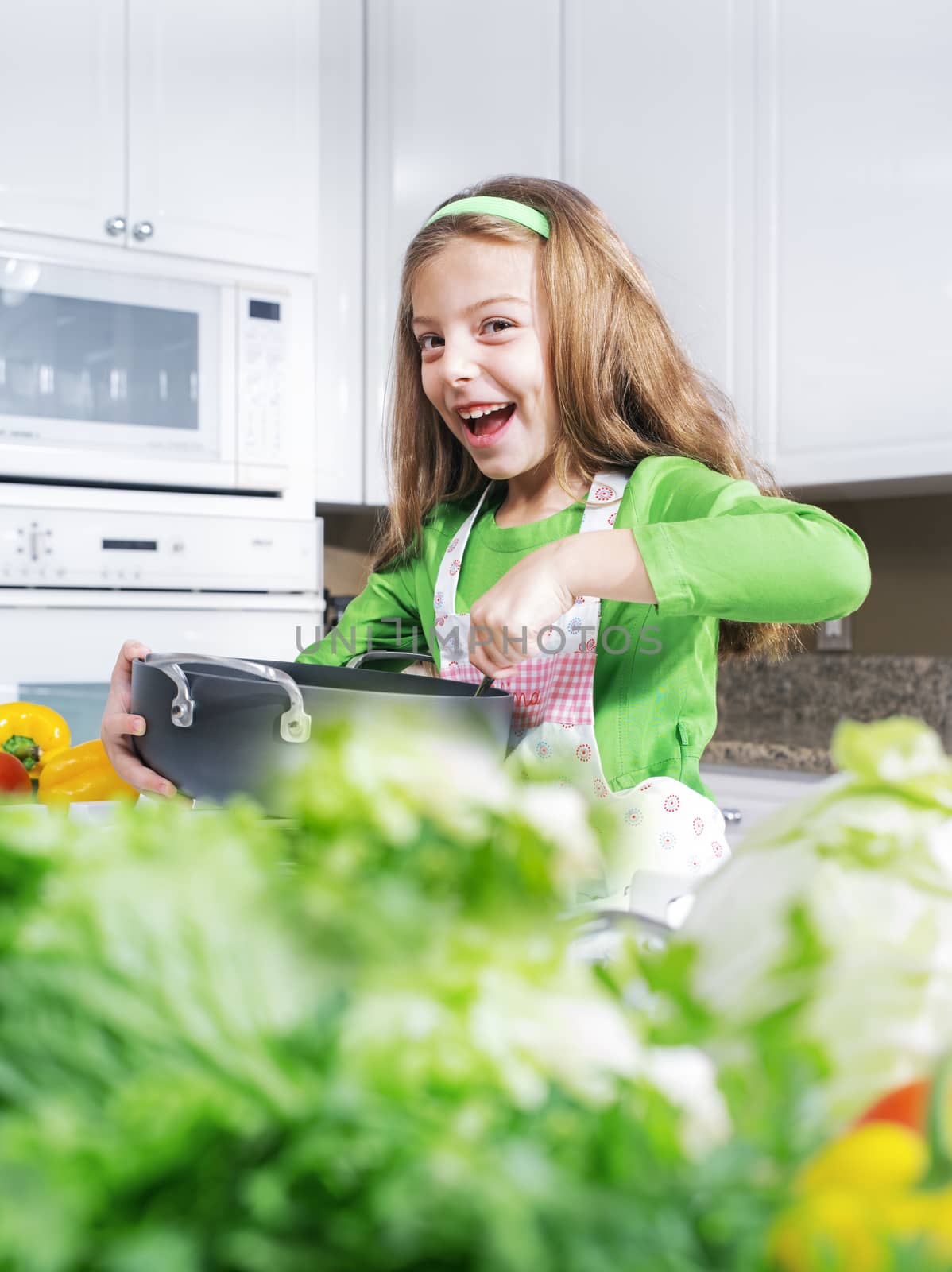 view of young beautiful girl cooking at the kitchen