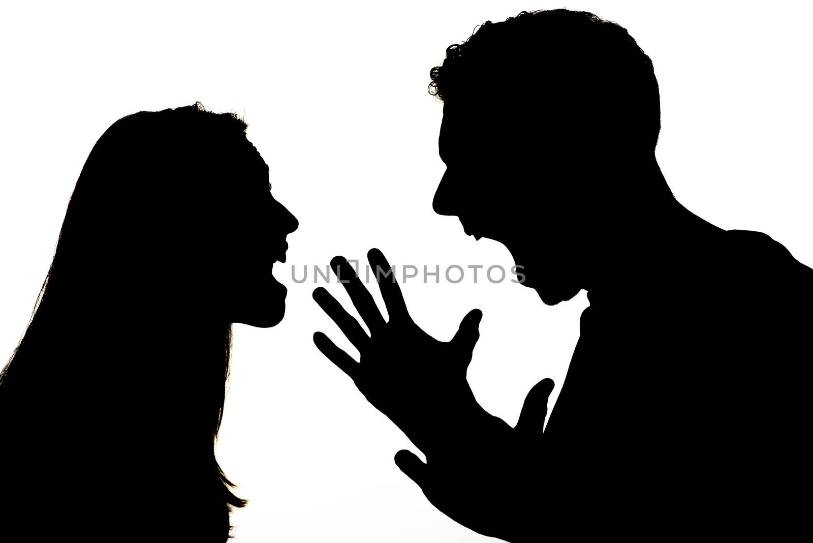 Silhouette of couple violence. They are angry and shouting face to face.