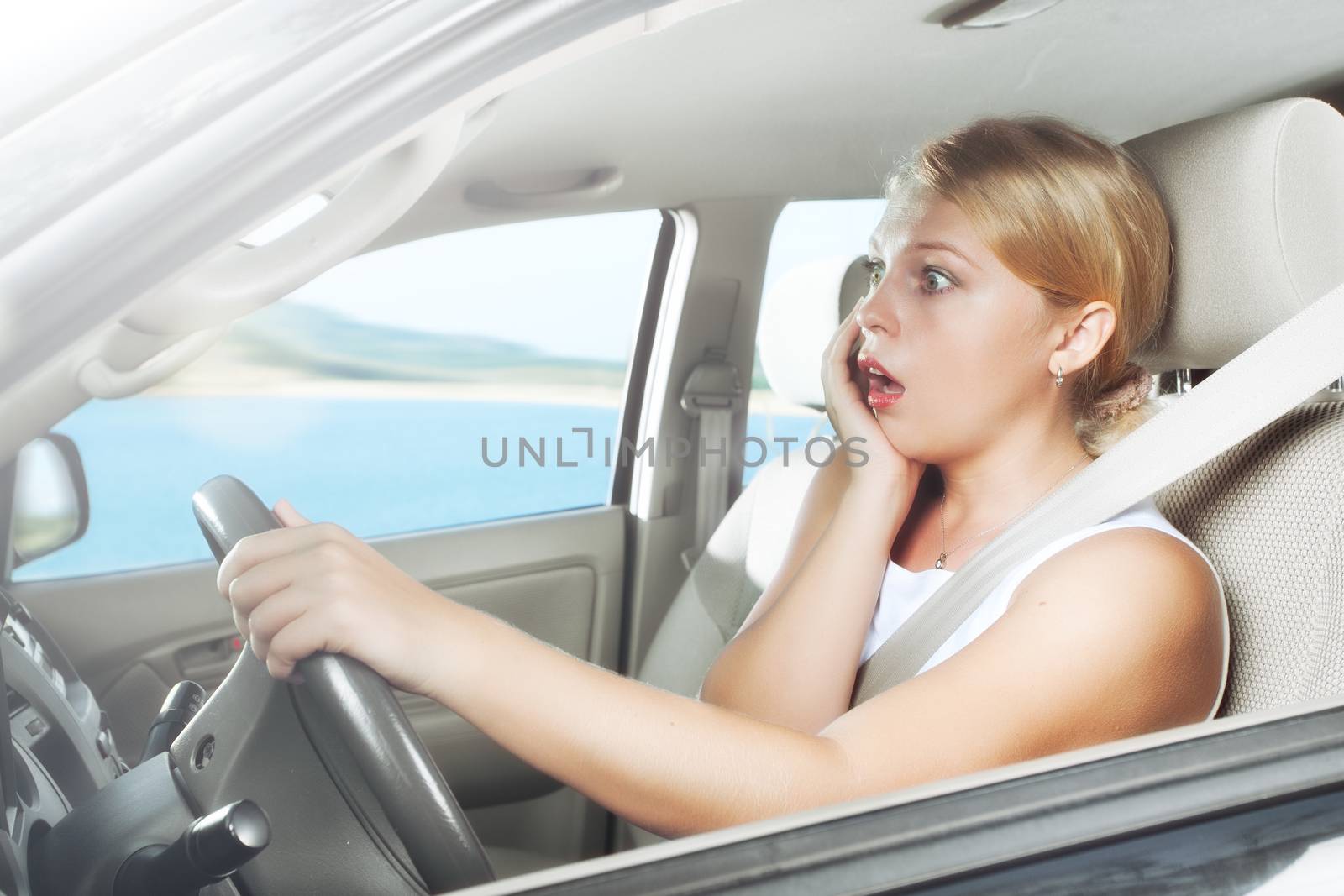 portrait of young beautiful woman sitting in the car