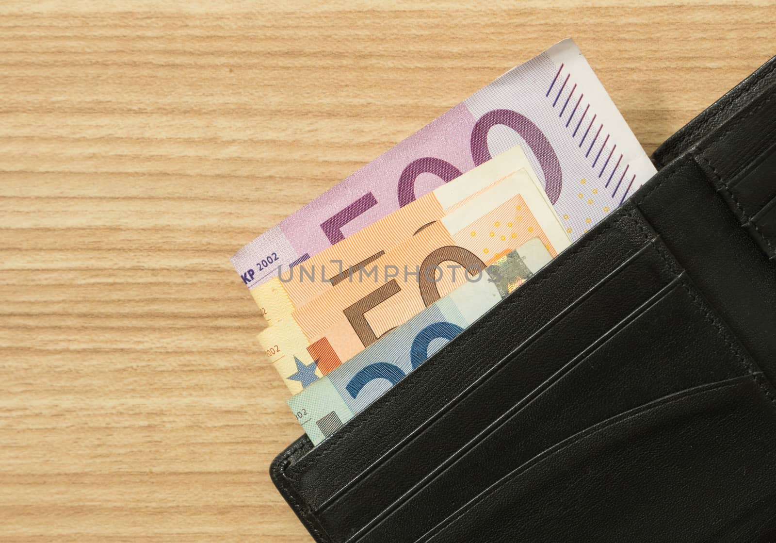 euro banknote in bag on wood table.