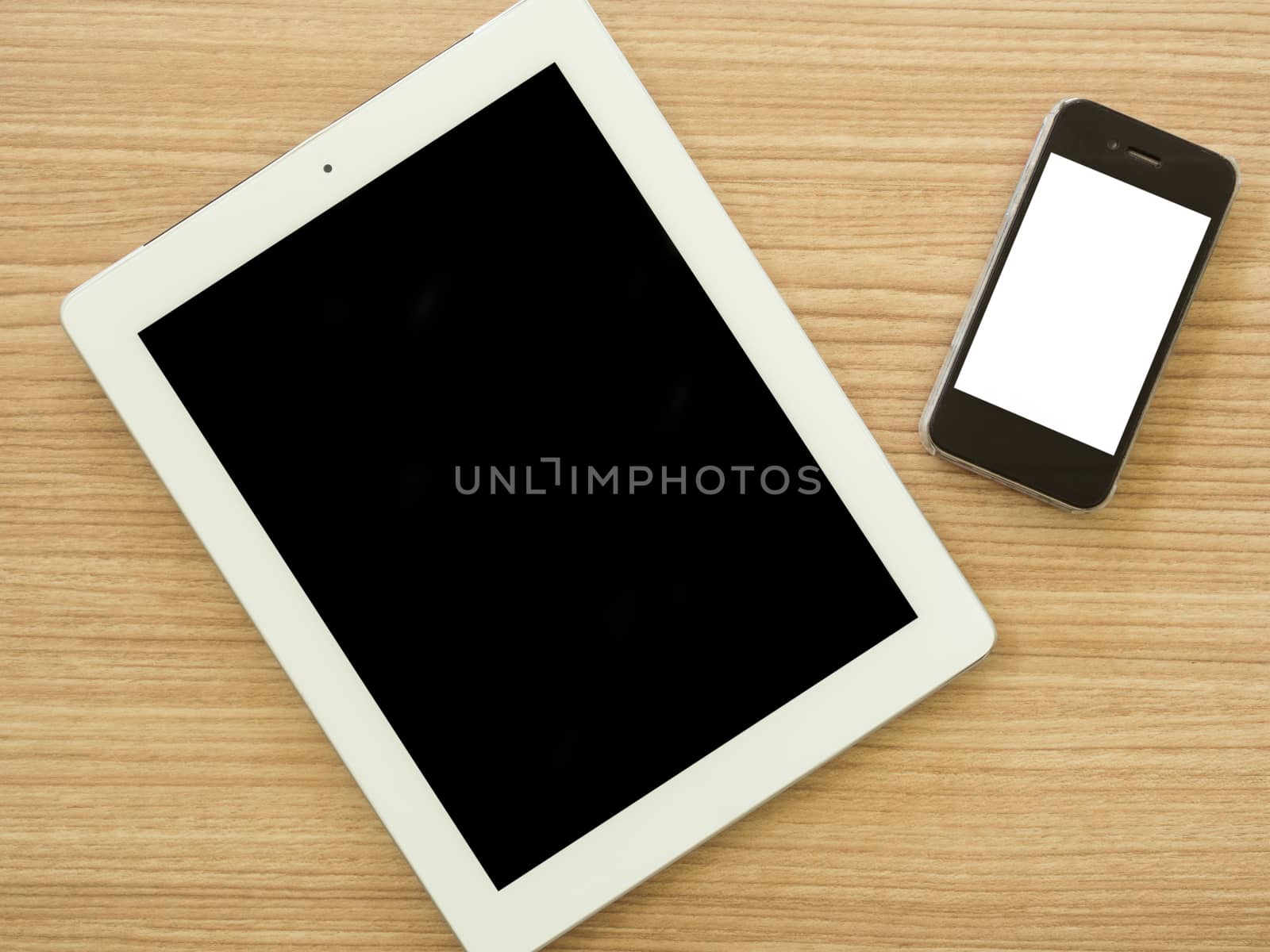 tablet computer and smart phone on wooden table