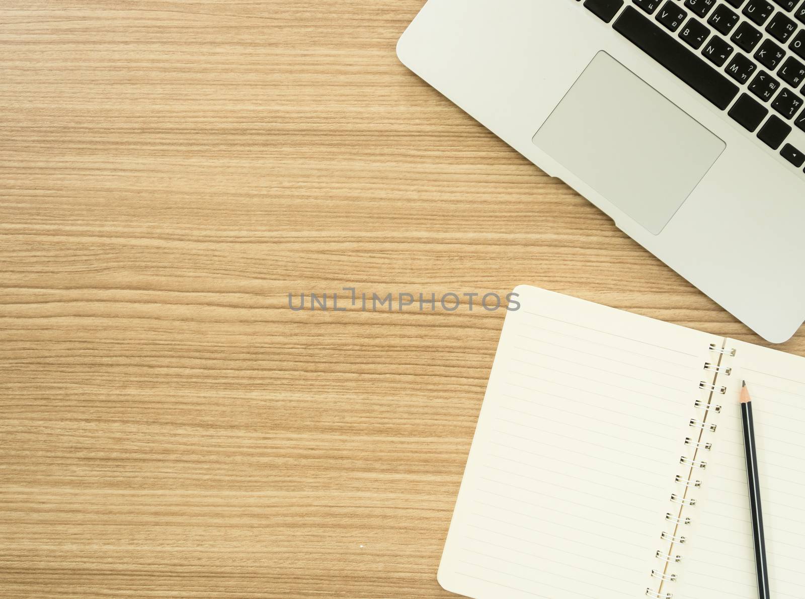 workspace with computer and notebook. View from above