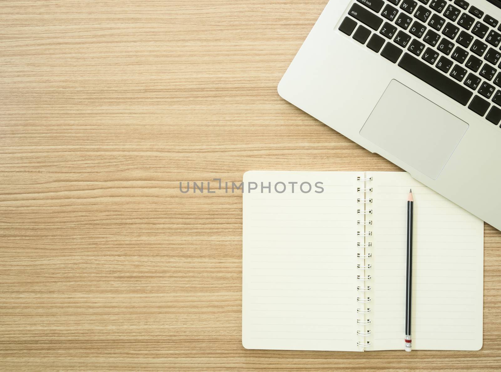 workspace with computer and notebook. View from above