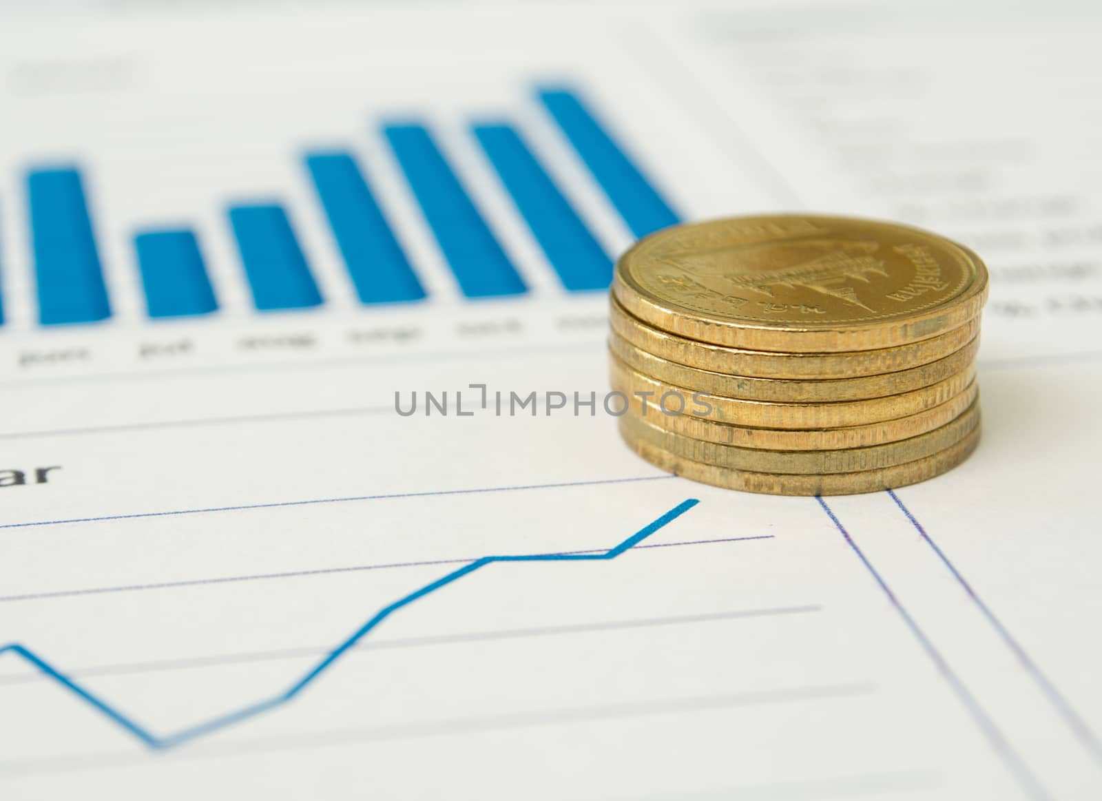 Gold coins and financial reports.  investment concept.  selective focus.