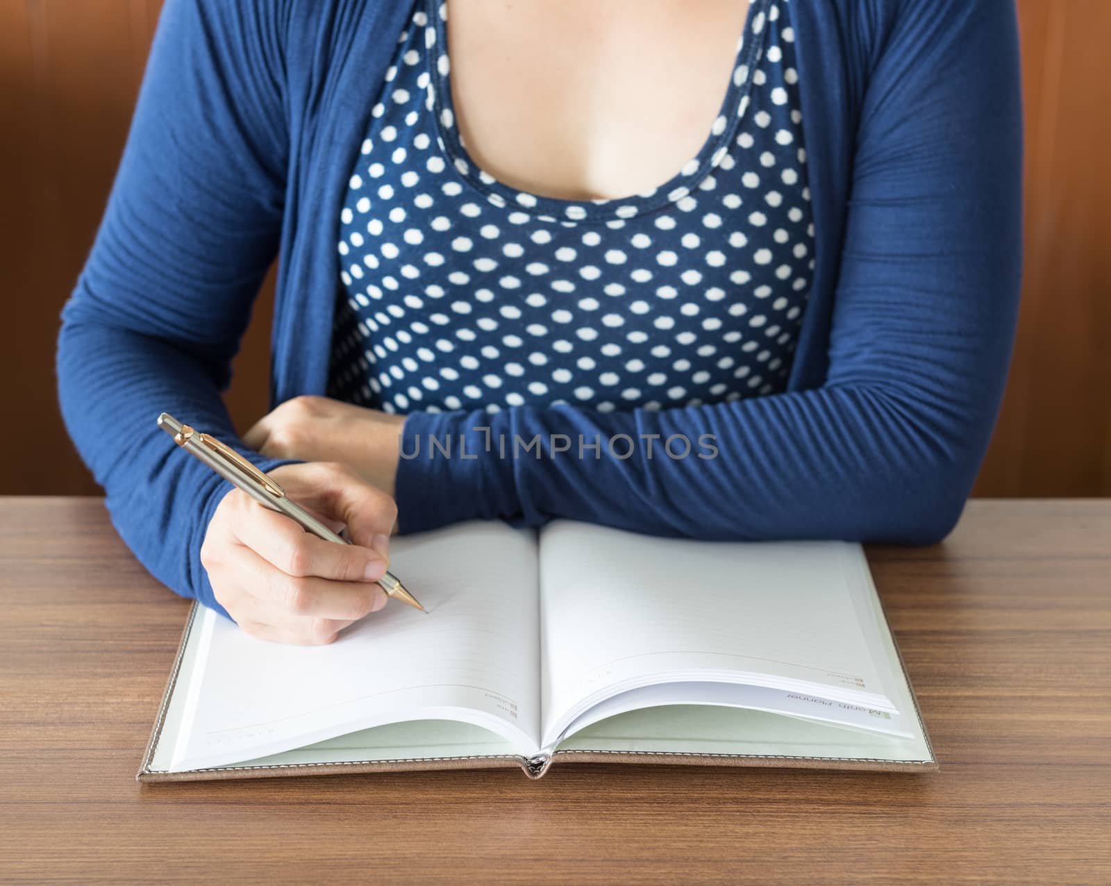 women are taking notes in a diary. select focus.