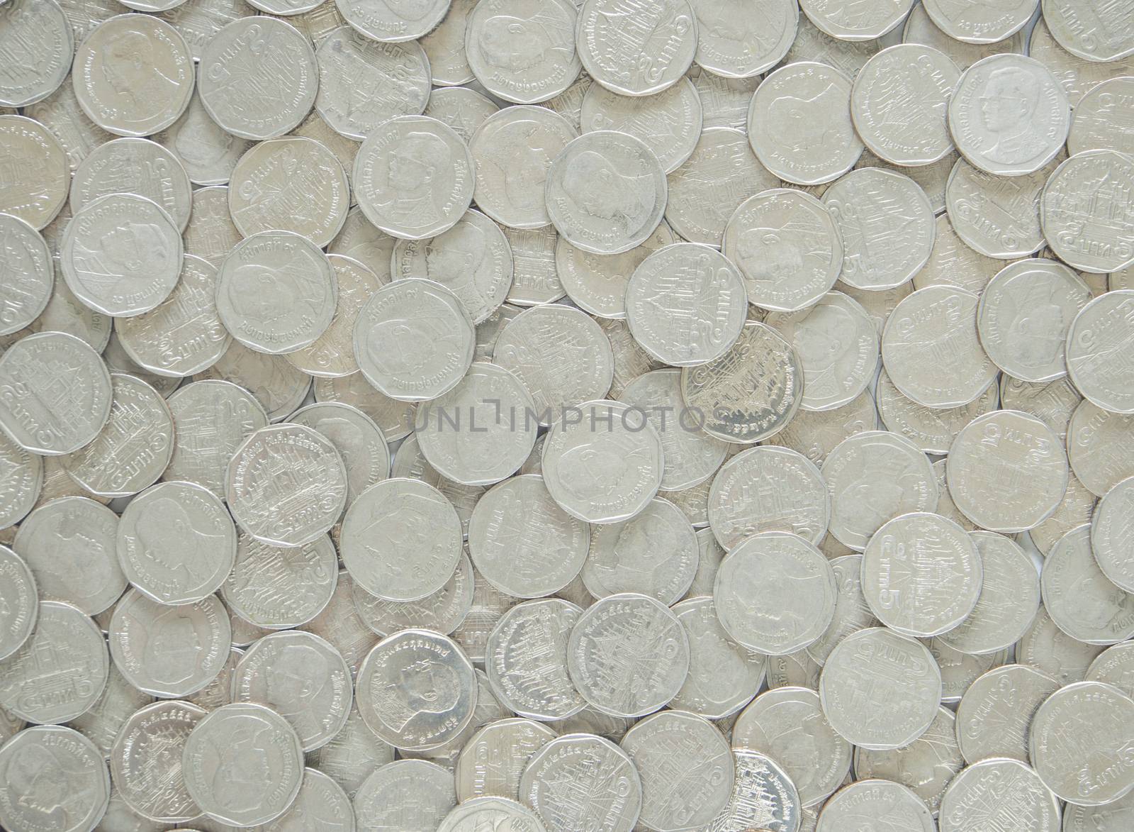 Silver metal coins used to cover the background.