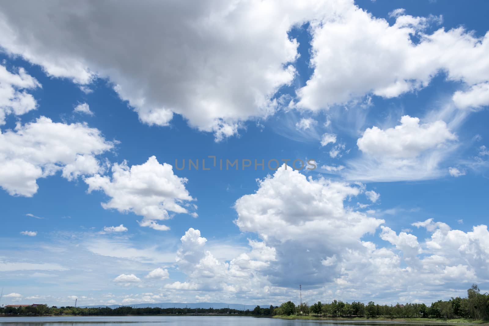 Abstract background of blue sky with white clouds and rain clouds.