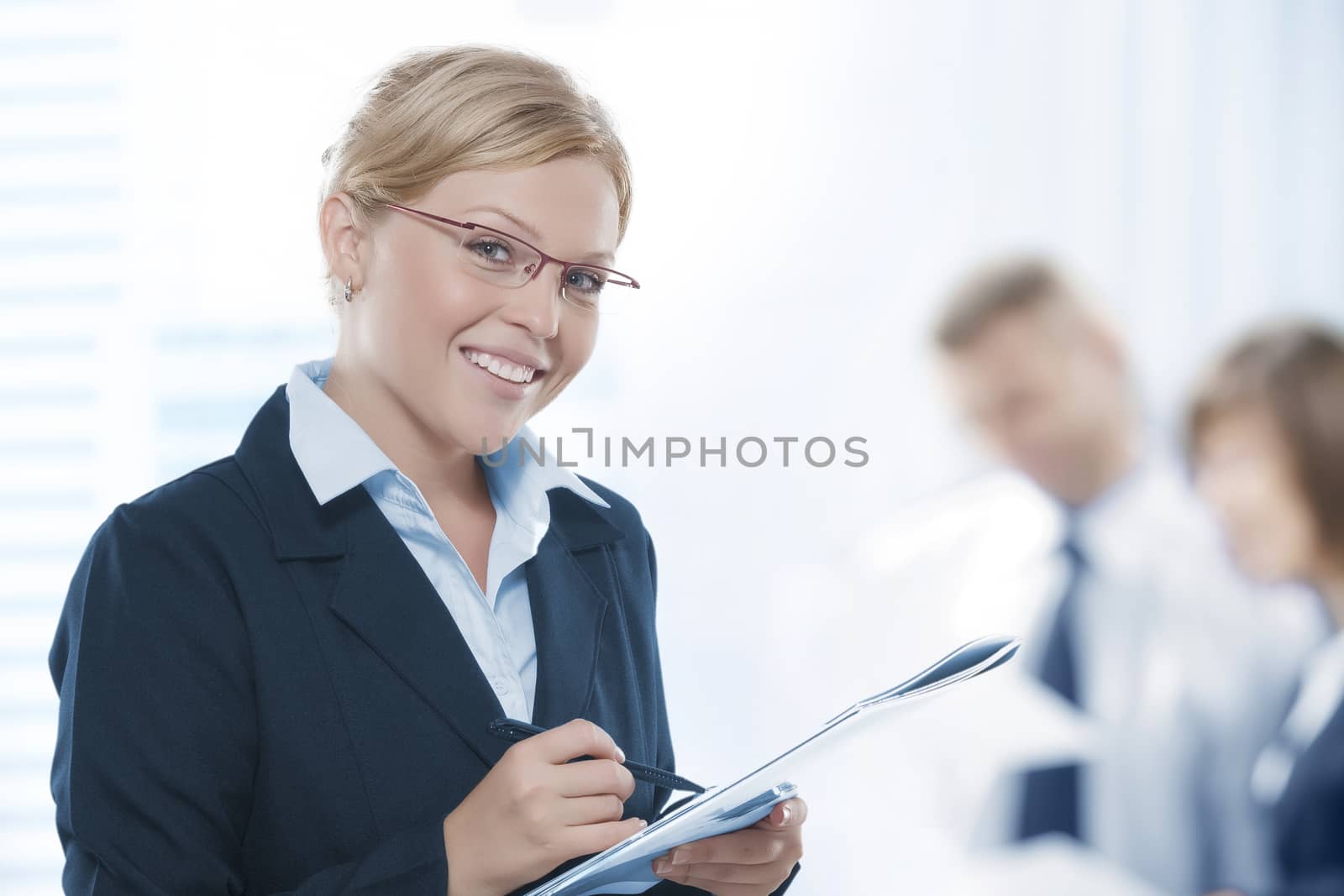 Portrait of young beautiful woman in office environment