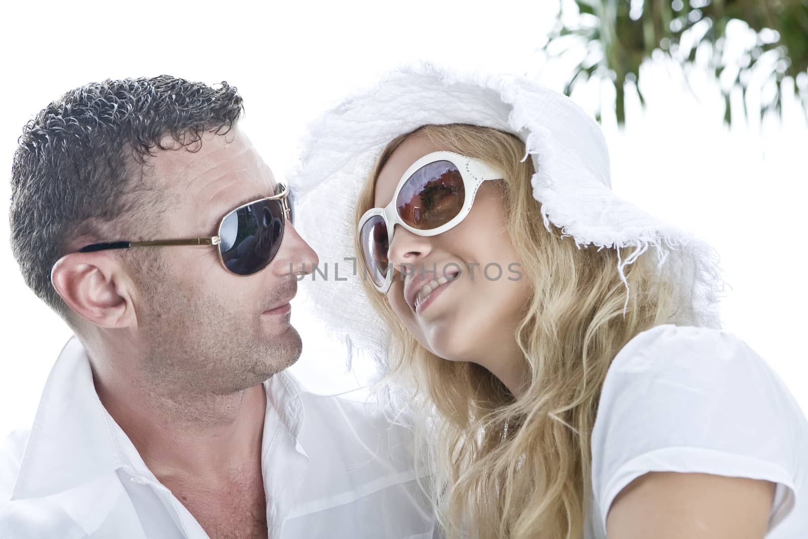 Portrait of young nice couple having good time on the beach